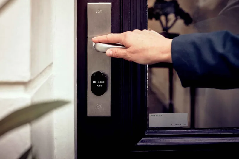 A guest unlocking a smart lock at a Dream Rentals home