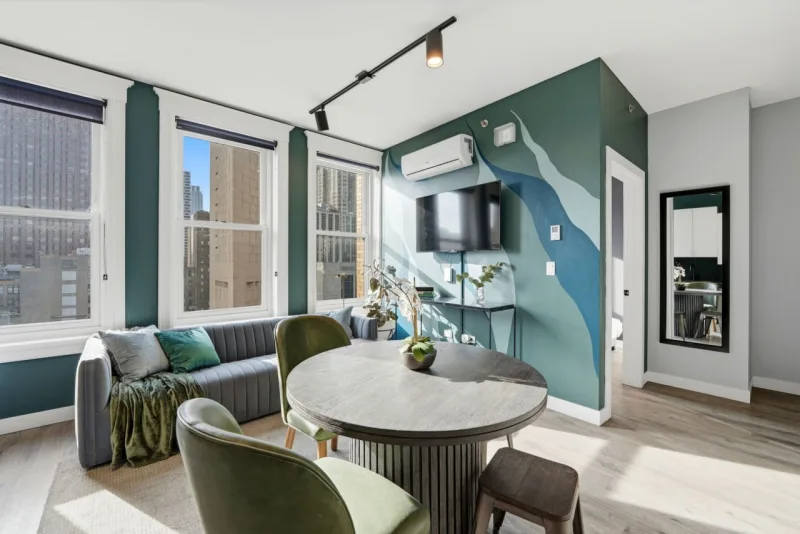 A bright, professionally staged living and dining area with city views, ready to list